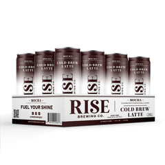 RISE Brewing Co. mocha cold brew can in a commuter bag beside keys and sunglasses for on-the-go energy