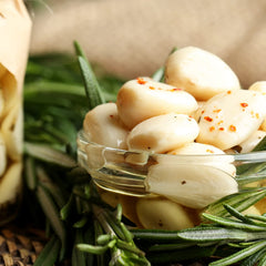 Open Sanniti jar revealing whole pickled garlic cloves ready to use for quick meals