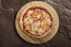 Schär pizza crust baked with toppings in kitchen showing easy entertaining