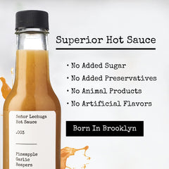 Señor Lechuga ingredients display with pineapple, garlic, and peppers — natural sourcing