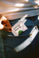 Simply Gum two unwrapped peppermint mints showing texture and natural peppermint oil benefit