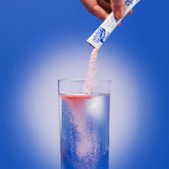 SINGLES TO GO! packet being mixed in a reusable bottle for on-the-go hydration