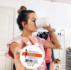Skinnygirl label close-up showing Rainforest Alliance and ingredient benefits