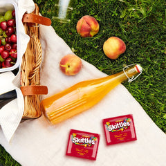 Skittles fun-size pouch in hand conveying convenient portion and handing out