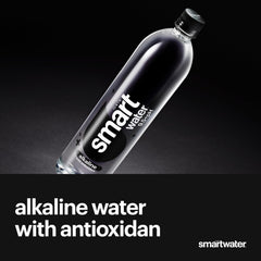 smartwater alkaline bottle in hand for scale and easy portability