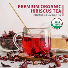 Soeos hibiscus steeping in a glass pitcher for iced tea, clear crimson hue