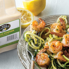 Spice Classics garlic powder rubbed onto meat to enhance savory grilling