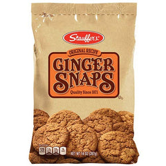 Stauffer's ginger snaps on a plate next to a cup of tea, perfect dunking pairing