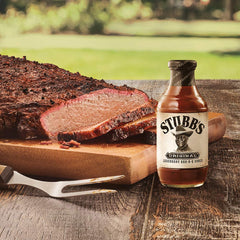 Thick Stubb's sauce pouring from spoon, showing texture and glazeability for grilling