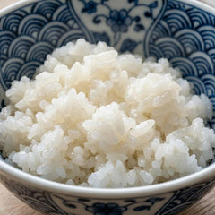 Bowl of rehydrated Sunnyside rice demonstrating tender texture and sauce absorption