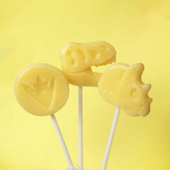 Sweetzo dino lollipop held in hand to show scale and easy party portioning