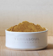 Terrasoul mesquite powder stirred into a smoothie bowl demonstrating flavor boost and visual appeal