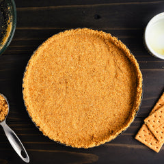 Mixing bowl with crumbs and melted butter from The Hampton Candy Company for crust prep