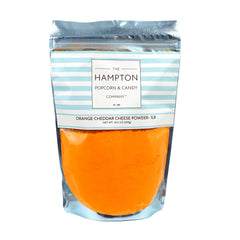 The Hampton Popcorn Company front of 1 lb cheddar powder bag showing label and resealable zip benefits