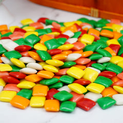 The Hampton Popcorn Company Chiclets next to a ruler showing size and piece count benefit