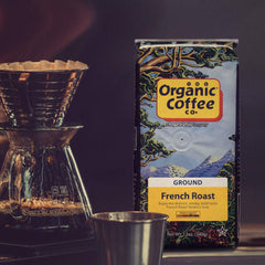12 oz bag beside a measuring scale and scoop showing The Organic Coffee Co. portion size and convenience benefit