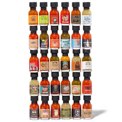 Thoughtfully overhead view of thirty mini glass bottles showing variety and colors