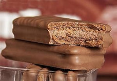 Hand holding Tim Tam to show scale and portion size benefit
