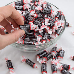 Tootsie Roll Midgeee beside a coin to show compact candy size