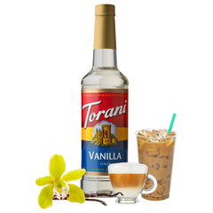 Torani bottle beside coffee cup for scale demonstrating bottle size