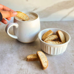 Tutti Gourmet biscotti served next to a steaming coffee cup illustrating perfect coffee pairing