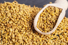 U.S. Wellness Naturals fenugreek seeds on spoon ready to measure, precise cooking benefit