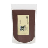 Valrhona front pouch showing brand and 1/2 lb repackaged cocoa — reliable premium baking ingredient