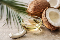 Vanilla Bean Kings pouring coconut extract into cake batter for consistent flavor benefit