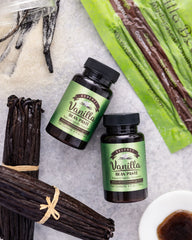 Spoonful of Vanilla Bean Kings paste pouring into bowl for easy mixing benefit