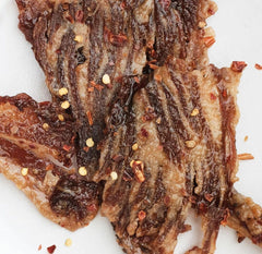 Weekend Jerky close-up texture of brisket strips showing tender, flavorful bite