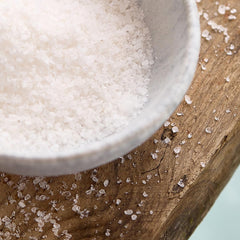 Westlab pouring salt into a bowl for bath preparation and easy measuring benefit
