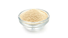 Yupik amaranth flour in a bowl beside baked goods demonstrating versatile use