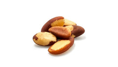 hand scooping Yupik Brazil nuts from bag illustrating portion size and scale