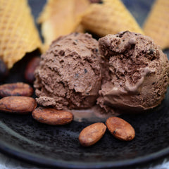 Yupik ground cacao powder on a scoop showing fresh grind and rich chocolate flavor