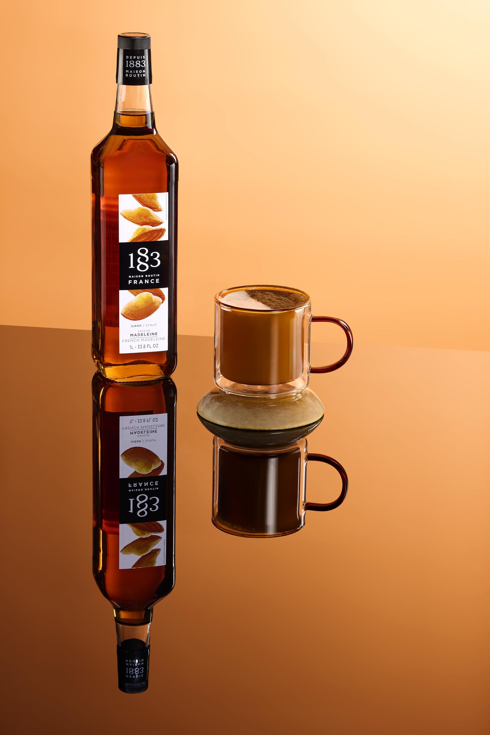 1883 Maison Routin bottle next to coffee cup showing scale and professional portioning