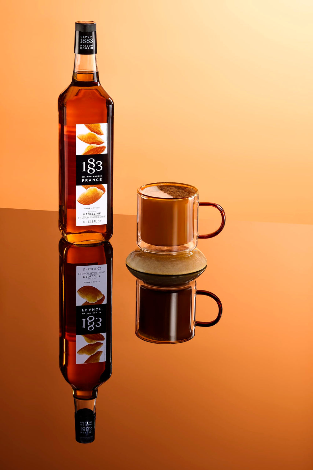 1883 Maison Routin bottle next to coffee cup showing scale and professional portioning