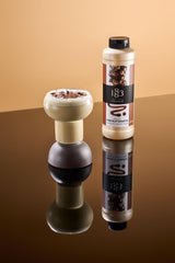 1883 Maison Routin pouring sauce into an espresso cup for richer mocha flavor