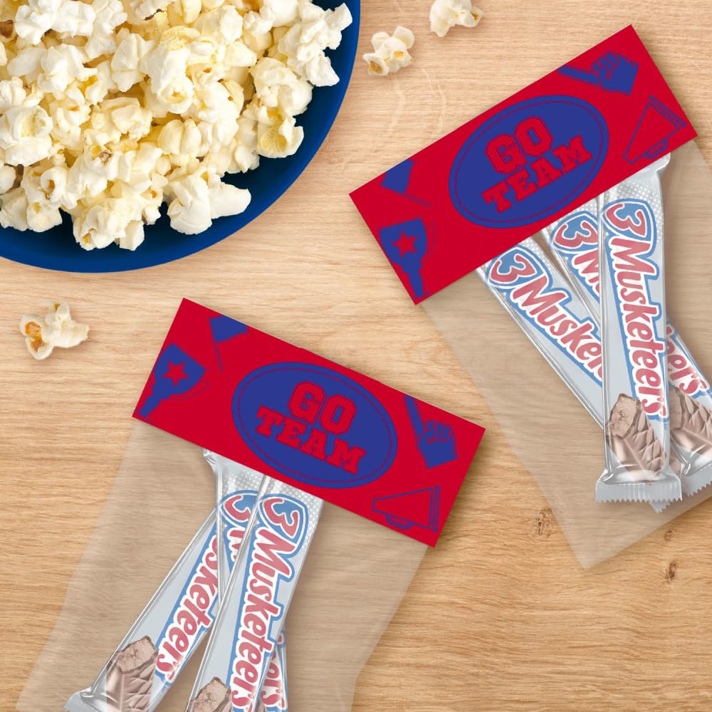 3 Musketeers bar held in hand to show full-size portion and value