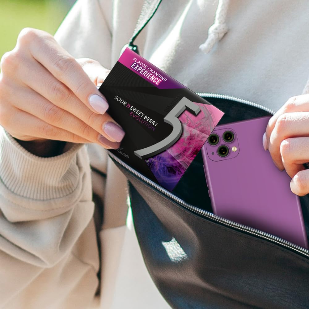 Hand holding 5 Gum Evolution pack to show size and pocket portability