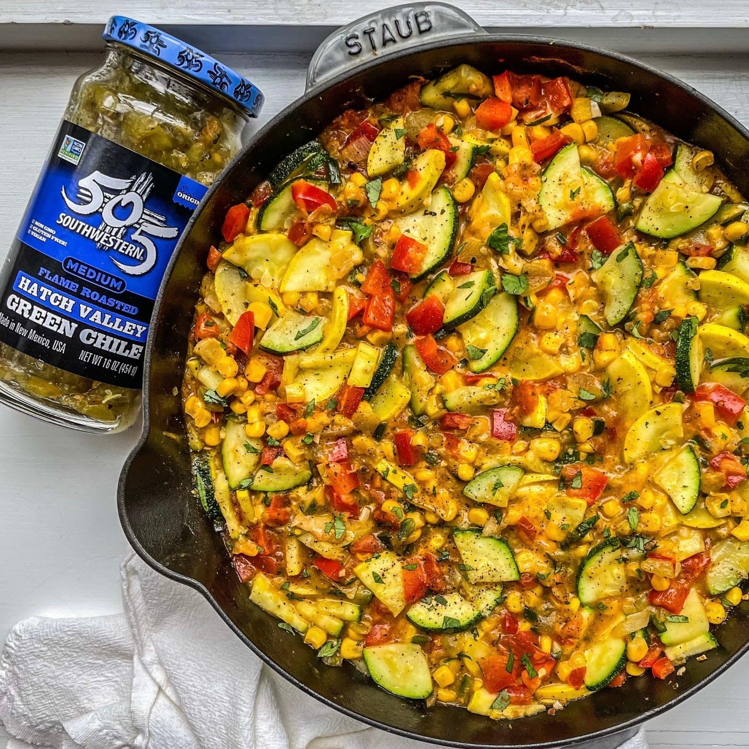 505 Southwestern spooned over enchiladas adding smoky medium heat and rich flavor