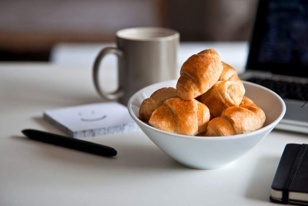 7Days croissant in hand demonstrating compact size and portable convenience