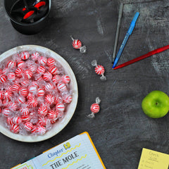 A Great Surprise peppermint ball beside a hand for size comparison, shows jumbo portion and ease of serving