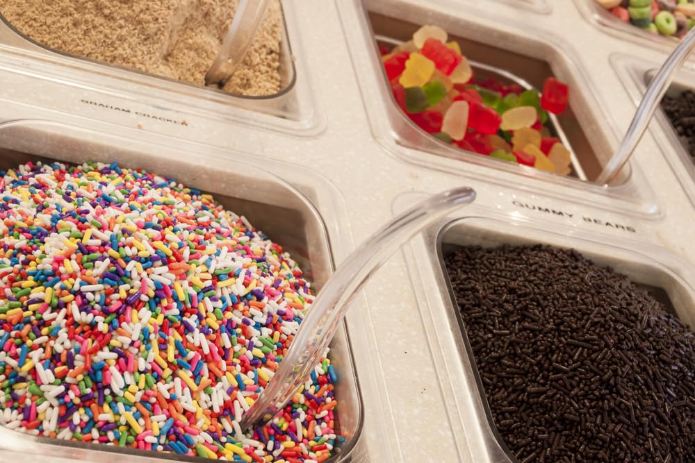 A Great Surprise spoonful of sprinkles over ice cream adding colorful contrast