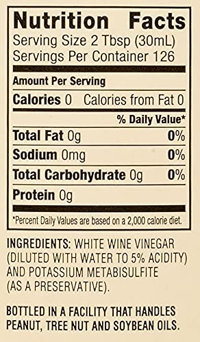Acclaim white wine vinegar used in kitchen making vinaigrette to boost fresh salad taste