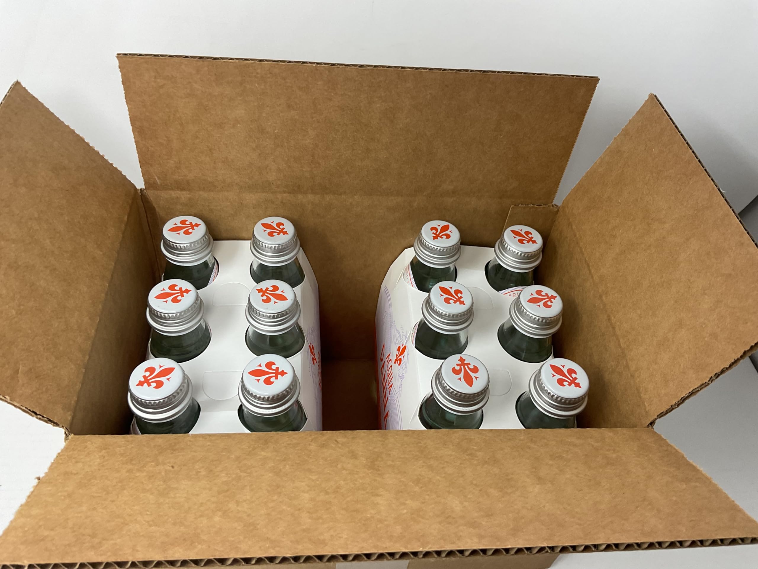 Acqua Panna bottle in hand demonstrating 8.8oz single-serve size and portability benefit