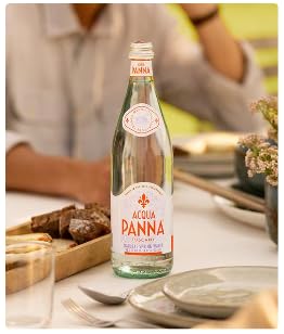 Acqua Panna bottle on a dining table showing refined pairing with food for better meals