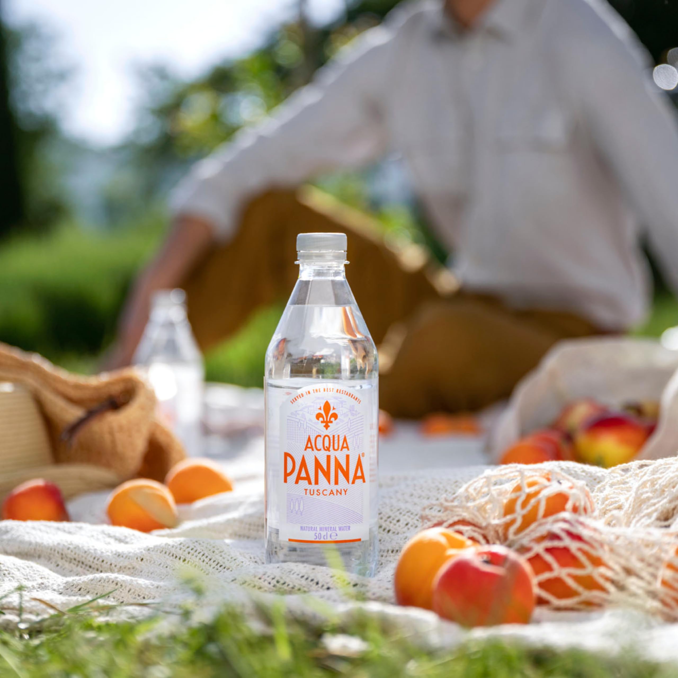 Acqua Panna on a dining table next to wine showing food-pairing harmony