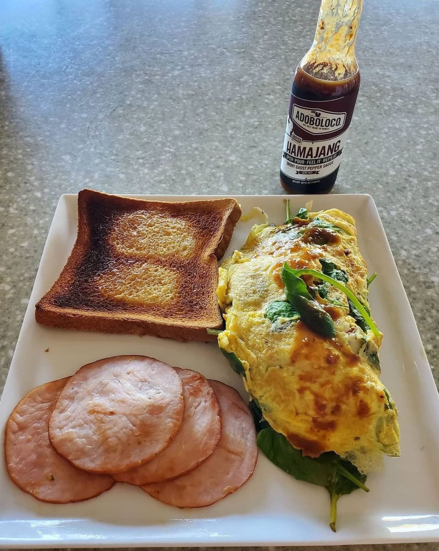 Adoboloco Hamajang on breakfast plate enhancing eggs with smoky spice