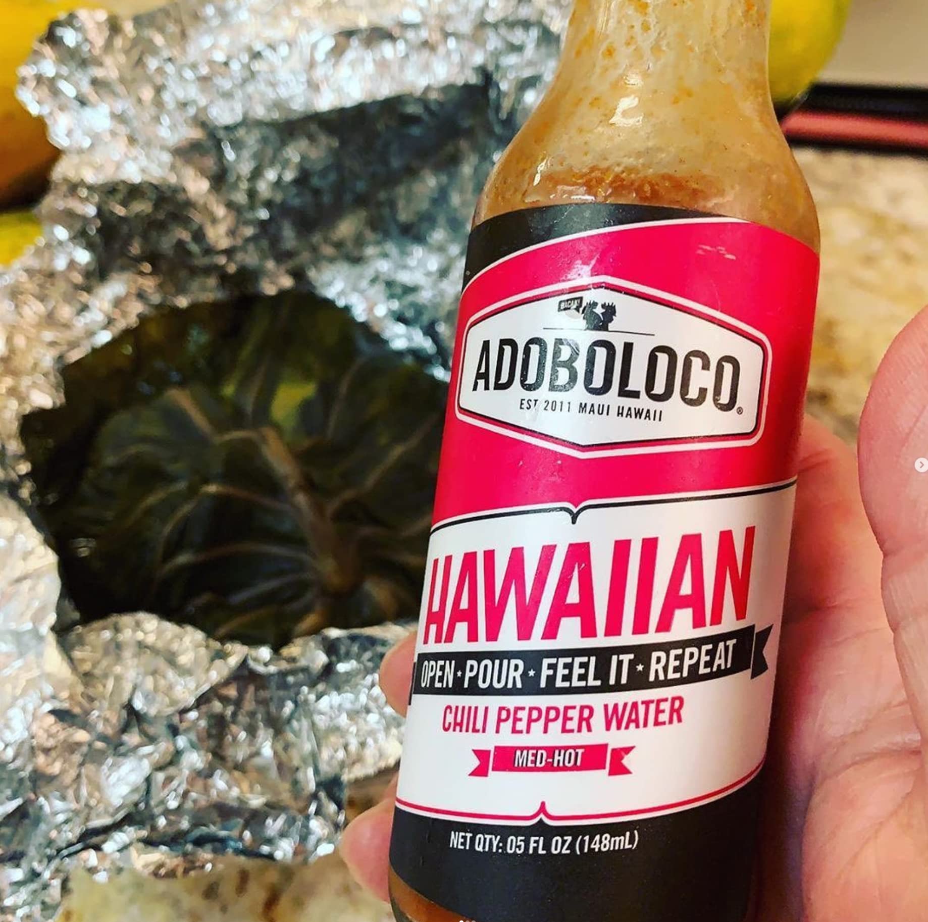 Adoboloco ingredients flatlay with peppers and vinegar showing natural recipe