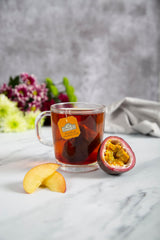 Ahmad Tea poured cup in a kitchen setting illustrating vibrant peach-passion aroma and serving suggestion